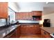 This kitchen features stainless steel appliances, dark countertops, and wood cabinets at 6309 Fairbanks Rd, Las Vegas, NV 89103