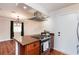Well-lit kitchen featuring stainless appliances, modern vent hood, and butcher block island at 6309 Fairbanks Rd, Las Vegas, NV 89103
