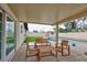 Covered patio with a conversation set overlooking the backyard and private pool at 6309 Fairbanks Rd, Las Vegas, NV 89103