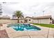 Backyard view of a sparkling pool with a palm tree, outdoor furniture and partially covered patio at 6309 Fairbanks Rd, Las Vegas, NV 89103