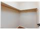 A walk-in closet with wooden rod and shelf at 6309 Fairbanks Rd, Las Vegas, NV 89103