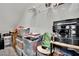 This attic features a sloped ceiling, storage solutions, and shelving perfect for keeping your home organized at 6945 Trevelez St, Las Vegas, NV 89149