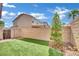 Well-kept backyard with desert landscaping, brick privacy walls, and artificial grass at 6945 Trevelez St, Las Vegas, NV 89149