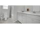 Bathroom featuring a double vanity with white cabinets and a shower-tub combo at 6945 Trevelez St, Las Vegas, NV 89149