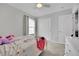 Bedroom with carpet, ceiling fan, and a large window with light streaming through at 6945 Trevelez St, Las Vegas, NV 89149