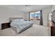 Bedroom with ample natural light, a plush bed, and neutral tones for relaxation at 6945 Trevelez St, Las Vegas, NV 89149