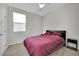 Cozy bedroom with plush carpet, a comfortable bed, and natural light at 6945 Trevelez St, Las Vegas, NV 89149
