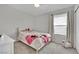 Bedroom features a large window with light streaming through and a ceiling fan at 6945 Trevelez St, Las Vegas, NV 89149