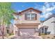 Inviting two-story home with a charming facade, complemented by a well-maintained front yard and mature tree at 6945 Trevelez St, Las Vegas, NV 89149