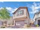 Charming two-story home featuring a stucco exterior and well-manicured landscaping, creating a welcoming curb appeal at 6945 Trevelez St, Las Vegas, NV 89149