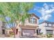 Inviting two-story home with a charming facade, complemented by a well-maintained front yard and mature tree at 6945 Trevelez St, Las Vegas, NV 89149