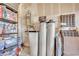 Organized garage featuring a water heater, softener, storage shelves, and supplies, maximizing space at 6945 Trevelez St, Las Vegas, NV 89149