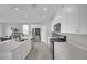 Modern kitchen with stainless steel appliances, sleek white cabinetry, and a stylish island with ample counter space at 6945 Trevelez St, Las Vegas, NV 89149