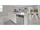 Open-concept kitchen featuring white cabinets, a large island, and stainless steel appliances at 6945 Trevelez St, Las Vegas, NV 89149
