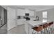 Modern kitchen with white cabinets, quartz countertops, stainless steel appliances, and bar seating at 6945 Trevelez St, Las Vegas, NV 89149
