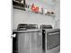 Modern laundry room equipped with front-load washer and dryer set, maximizing efficiency at 6945 Trevelez St, Las Vegas, NV 89149