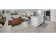 Bright and spacious open-concept living area with a modern kitchen and comfortable lounge seating at 6945 Trevelez St, Las Vegas, NV 89149