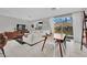 Open-concept living room featuring modern decor, tile flooring, and sliding glass doors at 6945 Trevelez St, Las Vegas, NV 89149