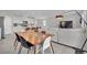 Open-concept living space featuring a stylish kitchen, dining area, and a comfortable living room with modern furnishings at 6945 Trevelez St, Las Vegas, NV 89149