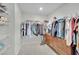 Walk-in closet with ample storage, clothing racks and custom wooden drawers at 6945 Trevelez St, Las Vegas, NV 89149