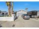 Front of home featuring neutral paint, desert landscaping, and a spacious driveway at 7026 Westpark Ct, Las Vegas, NV 89147