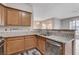 View of the kitchen featuring granite countertops, stainless steel sink and appliances, and wood cabinets at 7119 S Durango Dr # 312, Las Vegas, NV 89113