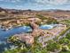 Expansive aerial shot of waterfront property with views of the serene lake, mountains, and lush landscaping at 72 Reverie Heights Ave, Henderson, NV 89011