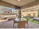An outdoor dining area and artificial turf for a low maintenance and relaxing backyard at 72 Reverie Heights Ave, Henderson, NV 89011