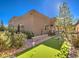 Home featuring a backyard with a putting green surrounded by lush landscaping, creating a private outdoor escape at 72 Reverie Heights Ave, Henderson, NV 89011