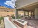Spacious outdoor entertaining area with a built-in grill, fire pit, and covered patio at 72 Reverie Heights Ave, Henderson, NV 89011