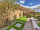 Backyard space featuring a putting green, mature trees, and retaining wall, offering a peaceful outdoor retreat at 72 Reverie Heights Ave, Henderson, NV 89011