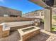 Backyard featuring a built-in grill, fire pit, seating, and landscaped surroundings at 72 Reverie Heights Ave, Henderson, NV 89011