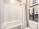 Clean bathroom featuring a tub shower and toilet with a bunny art piece at 72 Reverie Heights Ave, Henderson, NV 89011