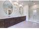 Modern bathroom featuring double sinks, sleek cabinets, and a glass-enclosed shower at 72 Reverie Heights Ave, Henderson, NV 89011