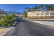 Lake Las Vegas community entrance with lush landscaping and palm trees on a clear day, with nearby bridge at 72 Reverie Heights Ave, Henderson, NV 89011