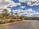 Gated community entrance with mature palms and landscaping, providing security at 72 Reverie Heights Ave, Henderson, NV 89011