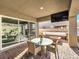 This covered patio features a glass table, chairs, and an outdoor TV for enjoying the outdoors at 72 Reverie Heights Ave, Henderson, NV 89011