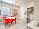 Bright dining area with red chairs, modern light fixture, and built in storage at 72 Reverie Heights Ave, Henderson, NV 89011