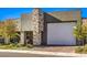 Modern home showcasing stucco and stone elements, a large garage door, and desert landscaping at 72 Reverie Heights Ave, Henderson, NV 89011