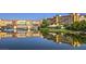 Scenic view of the colorful waterfront buildings reflected in the tranquil water, surrounded by lush greenery at 72 Reverie Heights Ave, Henderson, NV 89011