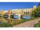 Charming waterfront buildings reflected in the tranquil waters of the lake with lush green landscaping at 72 Reverie Heights Ave, Henderson, NV 89011