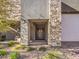 Charming home exterior featuring stone accents, a double door entry, and desert-friendly landscaping at 72 Reverie Heights Ave, Henderson, NV 89011