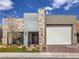 Contemporary home with mixed facade, an attached garage, and xeriscaped front yard at 72 Reverie Heights Ave, Henderson, NV 89011