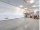 Spacious garage with epoxy flooring, high ceilings, storage loft, and an overhead door at 72 Reverie Heights Ave, Henderson, NV 89011