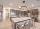 Large kitchen island features barstool seating, stone countertops, and modern cabinetry at 72 Reverie Heights Ave, Henderson, NV 89011