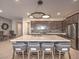 Open kitchen showcasing the large island with seating, modern appliances, and pendant lighting at 72 Reverie Heights Ave, Henderson, NV 89011