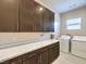 Well-equipped laundry room with ample countertop space and modern washer and dryer at 72 Reverie Heights Ave, Henderson, NV 89011