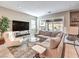 Comfortable living room with a large sectional sofa, modern decor, and access to the outdoor patio at 72 Reverie Heights Ave, Henderson, NV 89011