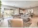 Stylish living room featuring a stone accent wall, comfortable seating, and patio access at 72 Reverie Heights Ave, Henderson, NV 89011