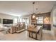 Bright, open-concept living space with modern decor, including a large dining table and wet bar at 72 Reverie Heights Ave, Henderson, NV 89011